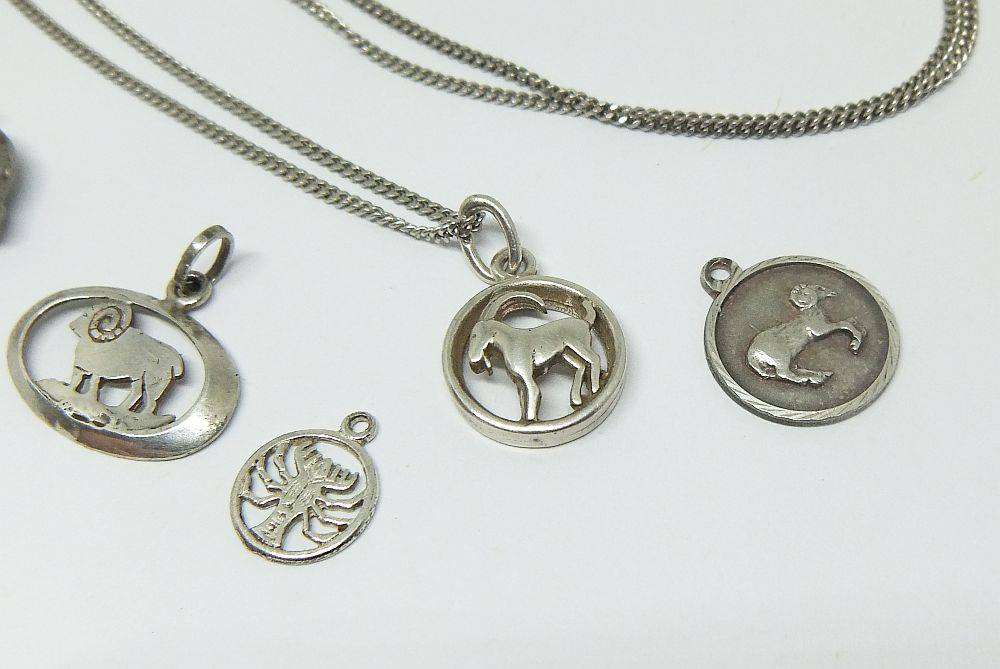 A long sterling silver necklace with a variety of 835 silver and sterling silver pendants or charms