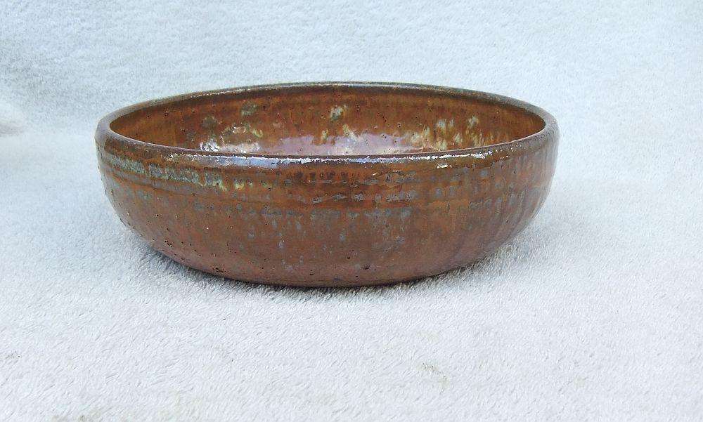 A large pottery serving bowl with makers stamp possibly by Hyme Rabinowitz