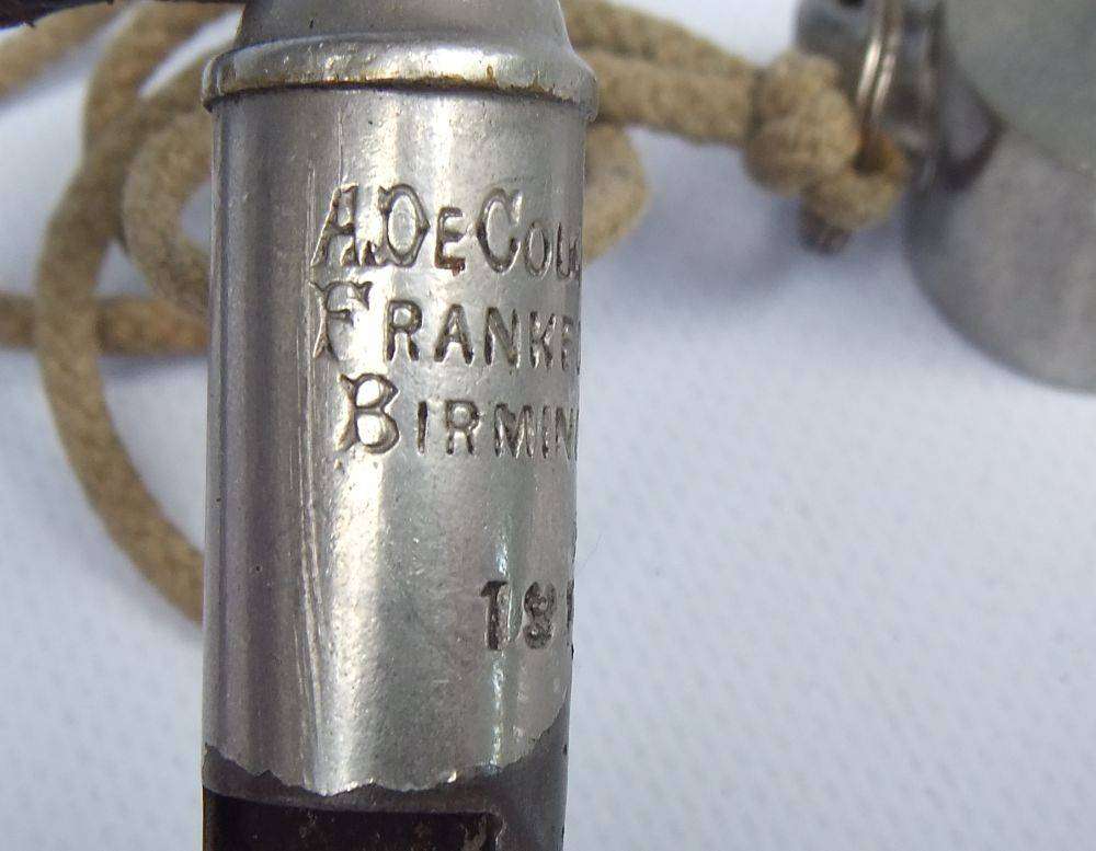 An antique 1917 WW1 whistle and a vintage The Acme Thunderer whistle