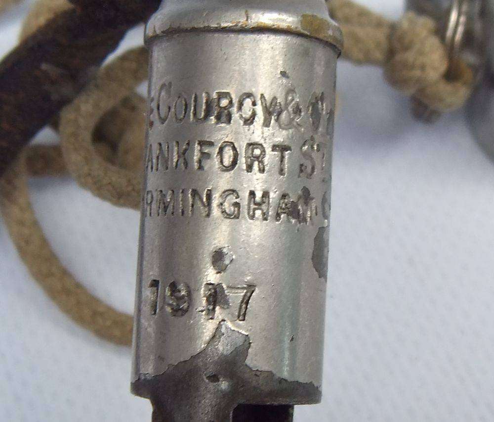 An antique 1917 WW1 whistle and a vintage The Acme Thunderer whistle