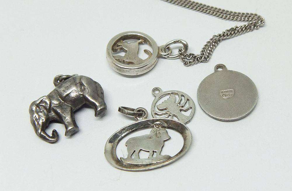 A long sterling silver necklace with a variety of 835 silver and sterling silver pendants or charms