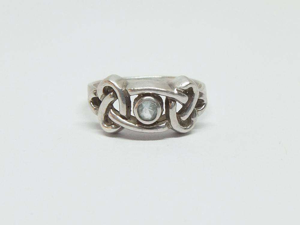A stunning Celtic motif sterling silver ring set with a faceted pale blue stone