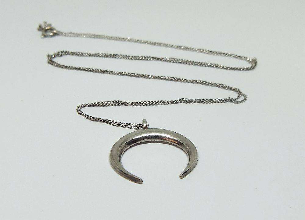 A long sterling silver necklace with a sterling silver crescent moon pendant in great condition