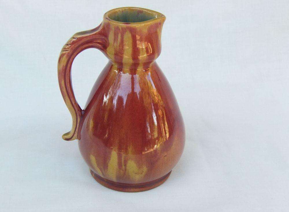 A heavy thick vintage glazed pottery ewer with makers markings on base