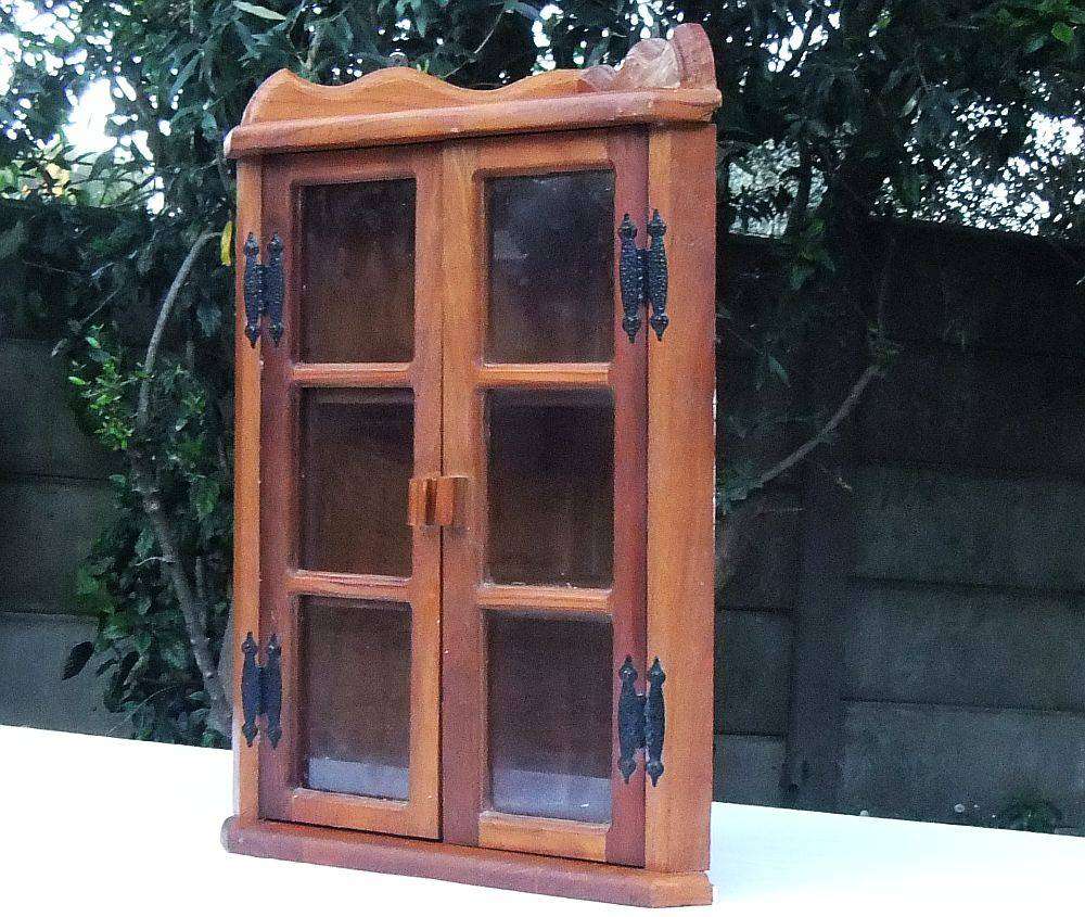 A stunning vintage wooden corner display cabinet with shelving for your collectables