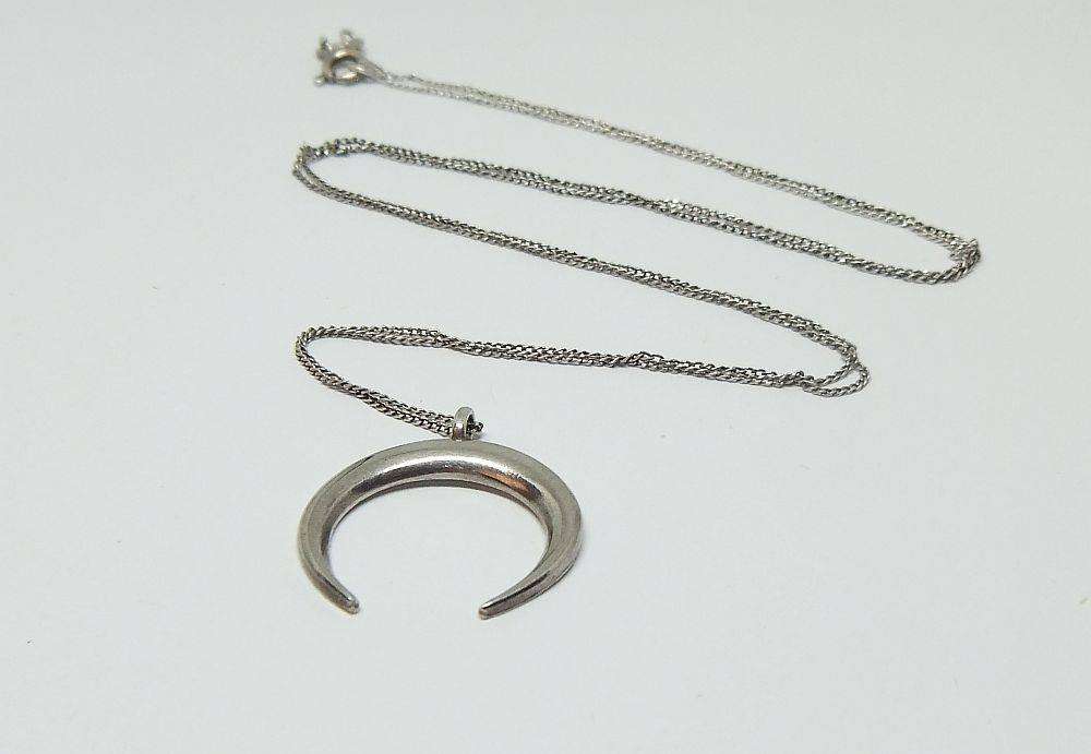 A long sterling silver necklace with a sterling silver crescent moon pendant in great condition