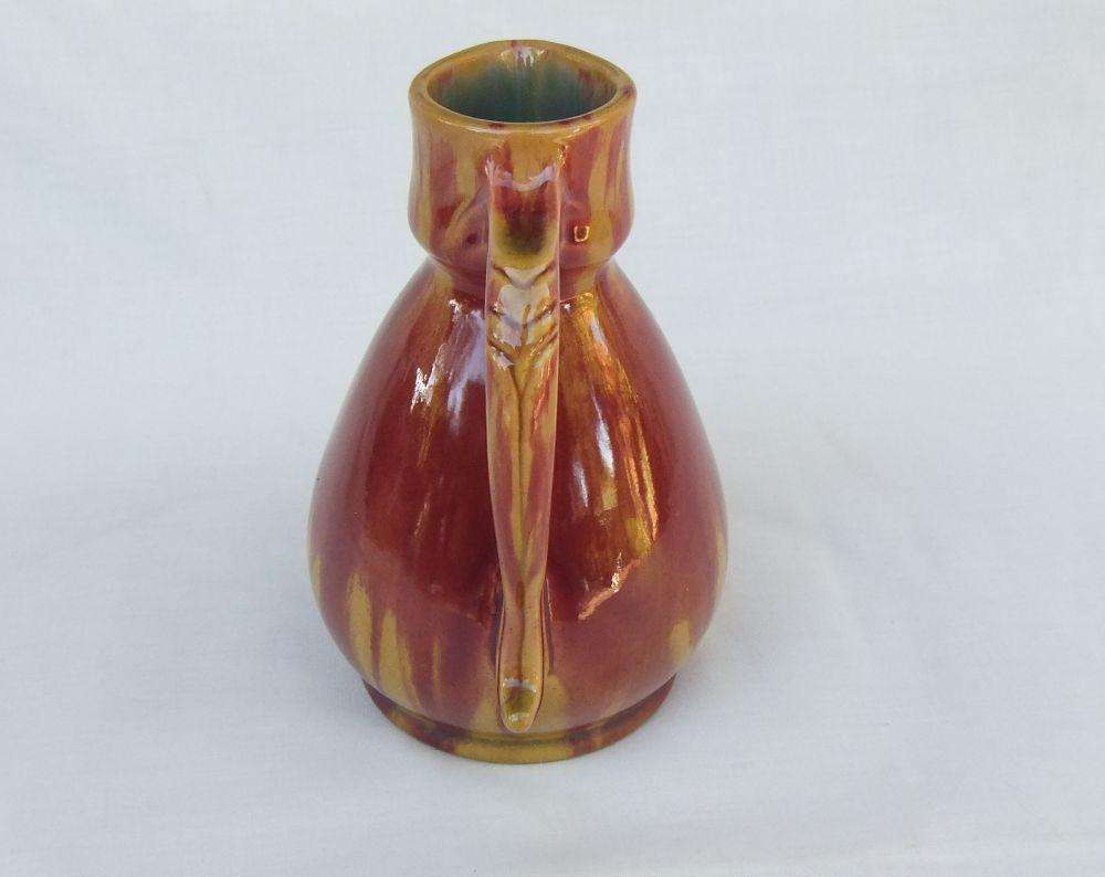 A heavy thick vintage glazed pottery ewer with makers markings on base