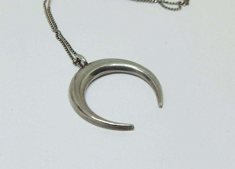 A long sterling silver necklace with a sterling silver crescent moon pendant in great condition