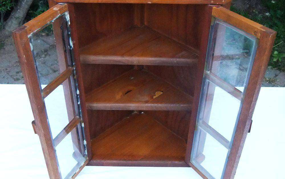 A stunning vintage wooden corner display cabinet with shelving for your collectables