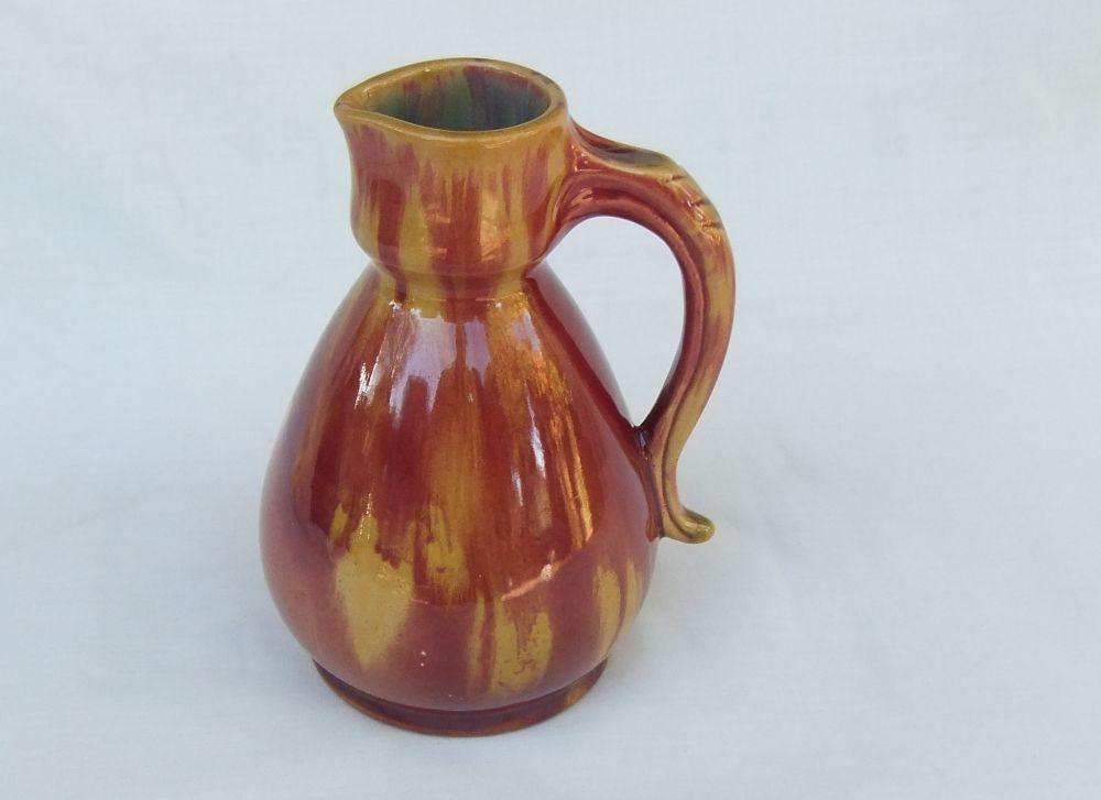 A heavy thick vintage glazed pottery ewer with makers markings on base