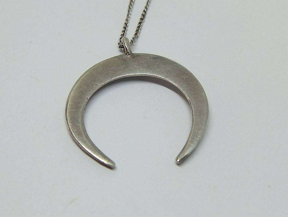A long sterling silver necklace with a sterling silver crescent moon pendant in great condition