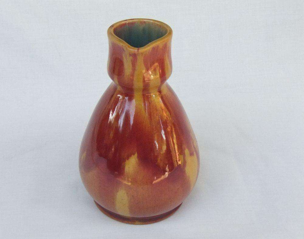 A heavy thick vintage glazed pottery ewer with makers markings on base