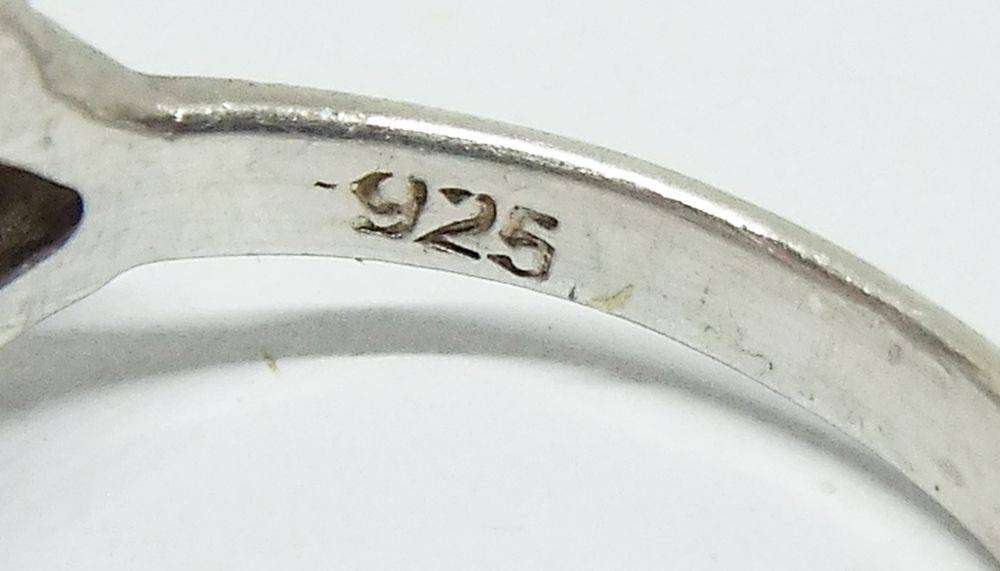 A stunning Celtic motif sterling silver ring set with a faceted pale blue stone