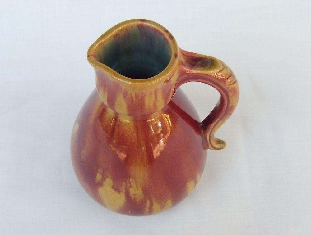 A heavy thick vintage glazed pottery ewer with makers markings on base