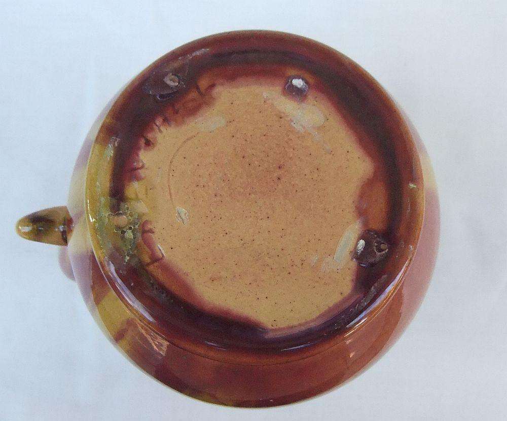 A heavy thick vintage glazed pottery ewer with makers markings on base