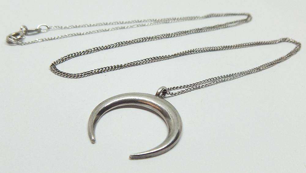 A long sterling silver necklace with a sterling silver crescent moon pendant in great condition