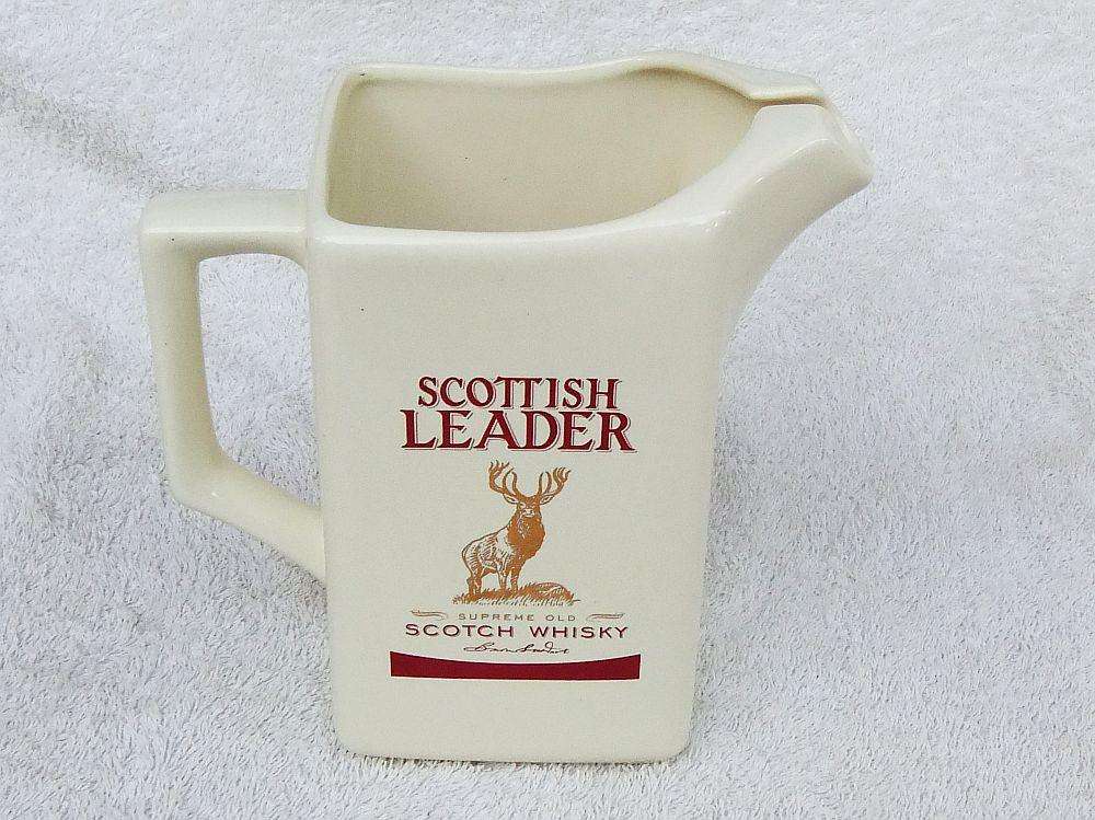 A vintage Scottish Leader Whisky advertising water jug