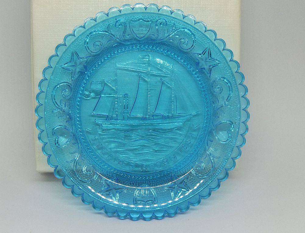 A boxed miniature blue pressed glass plate commemorating the Acorn Steamship in excellent condition
