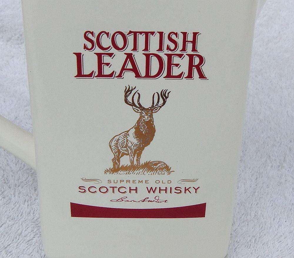 A vintage Scottish Leader Whisky advertising water jug