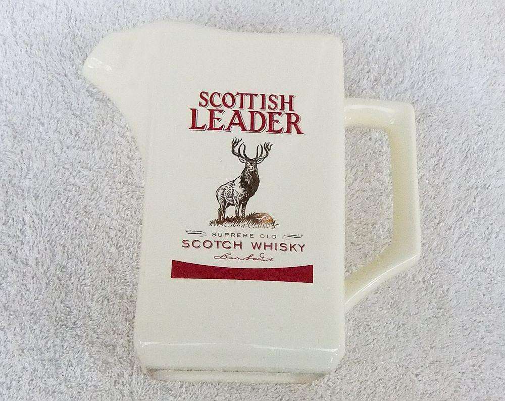 A vintage Scottish Leader Whisky advertising water jug