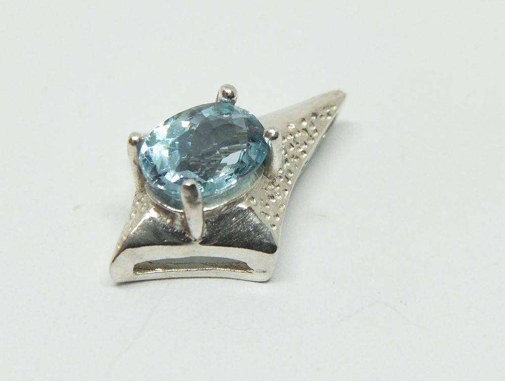 A unique vintage sterling silver pendant with a gorgeous faceted blue inset