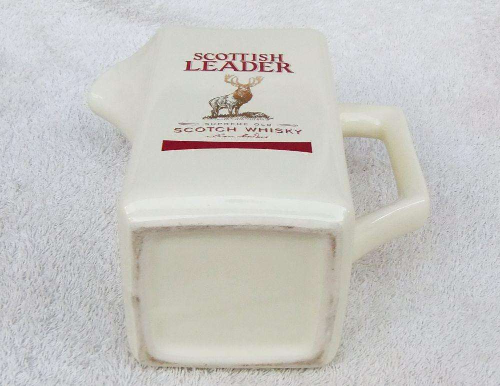 A vintage Scottish Leader Whisky advertising water jug