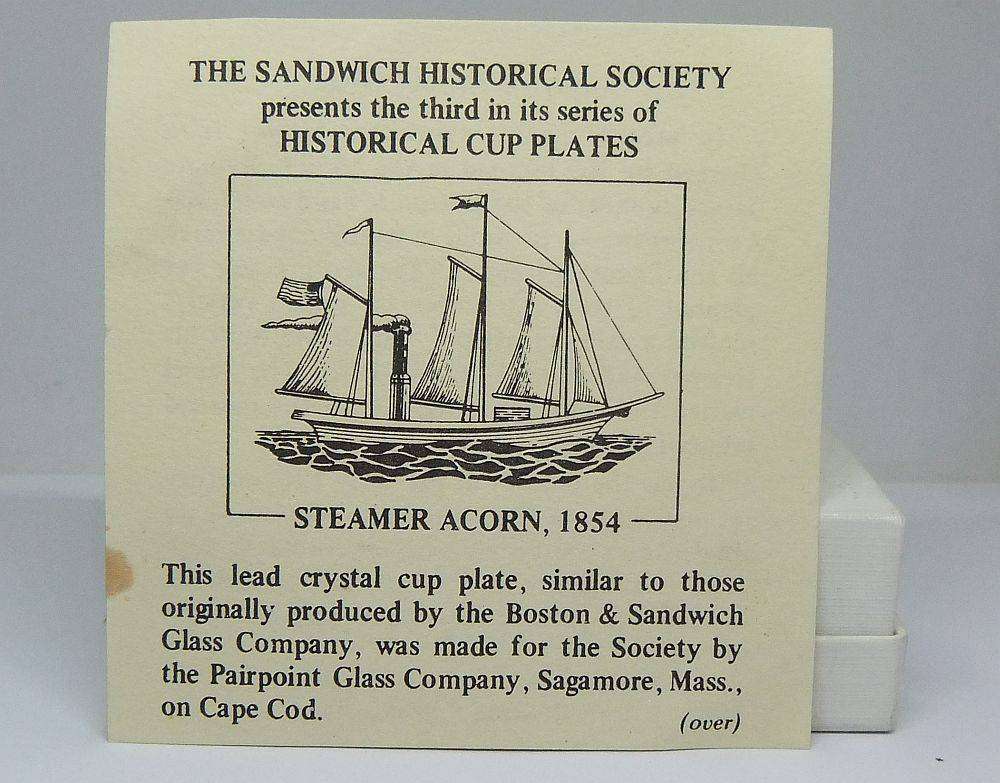 A boxed miniature blue pressed glass plate commemorating the Acorn Steamship in excellent condition