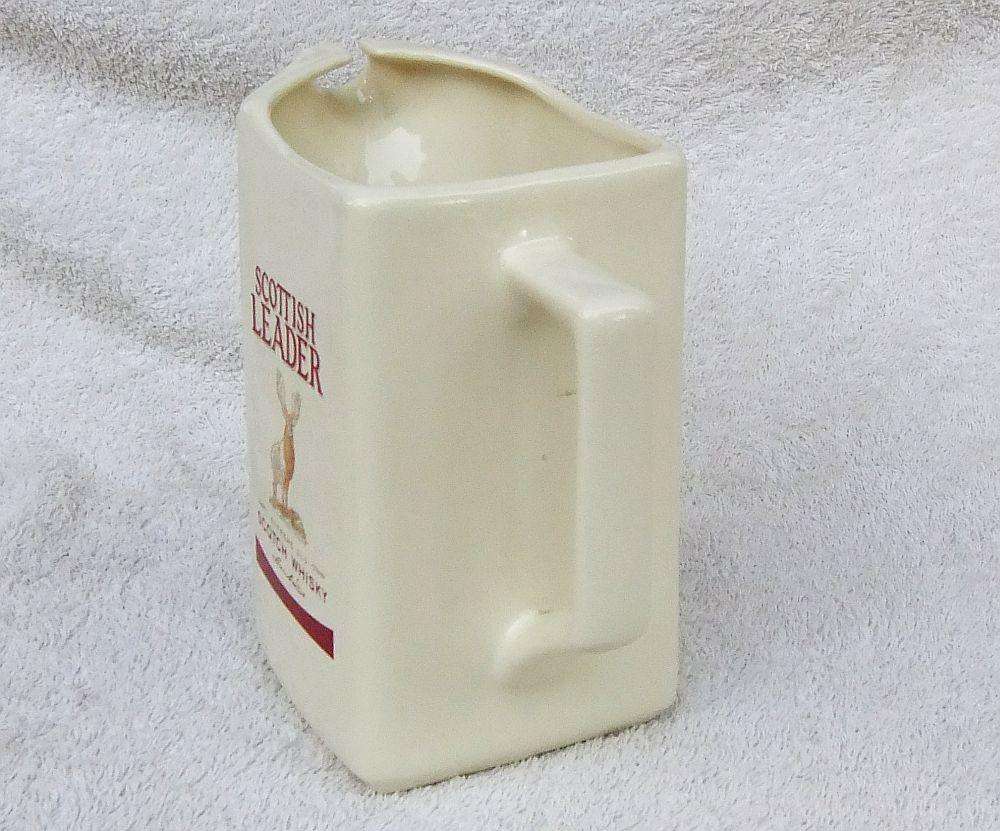 A vintage Scottish Leader Whisky advertising water jug