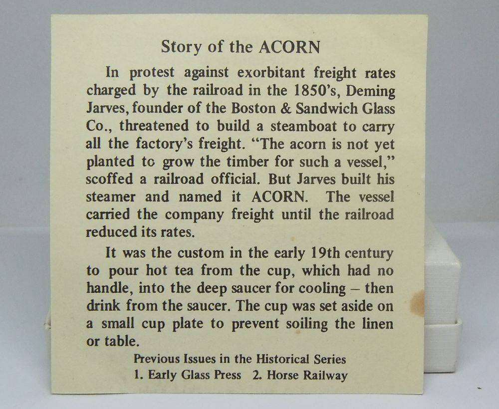 A boxed miniature blue pressed glass plate commemorating the Acorn Steamship in excellent condition