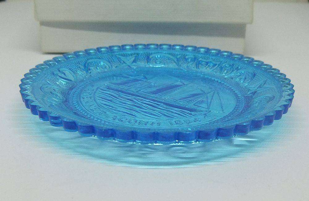 A boxed miniature blue pressed glass plate commemorating the Acorn Steamship in excellent condition