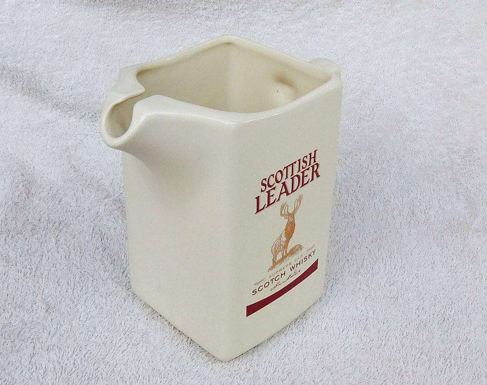 A vintage Scottish Leader Whisky advertising water jug