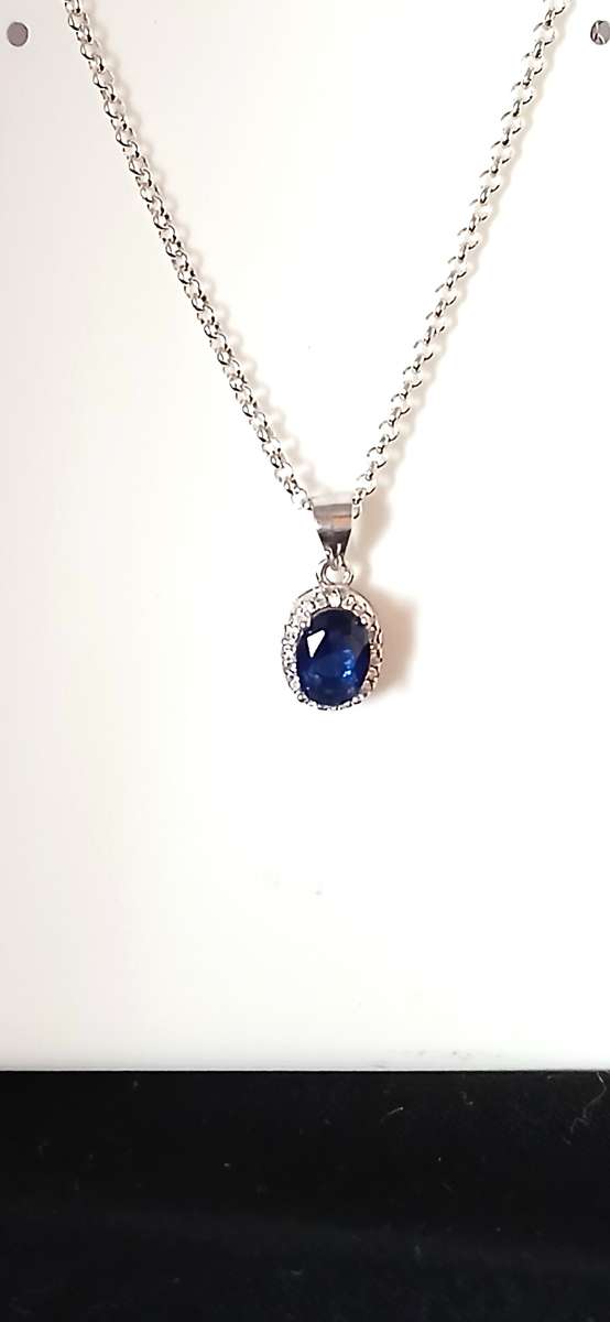 Sterling silver pendant with blue stone on chain