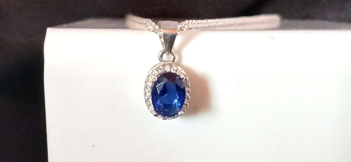 Sterling silver pendant with blue stone on chain