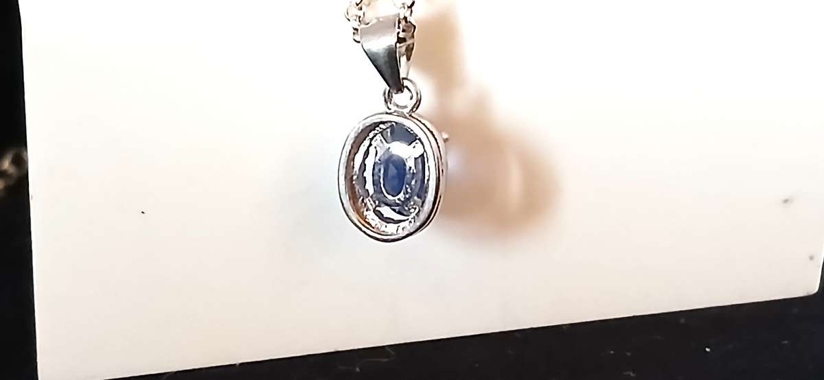 Sterling silver pendant with blue stone on chain