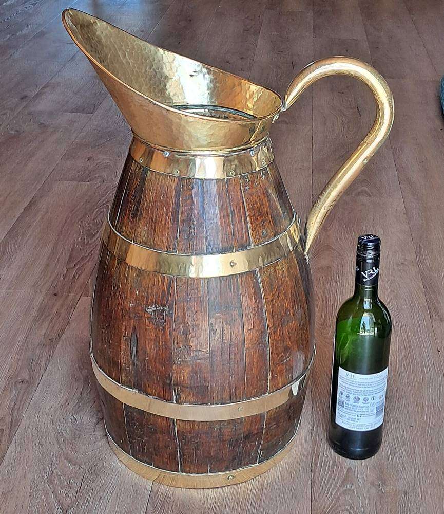 Large antique oak and brass jug