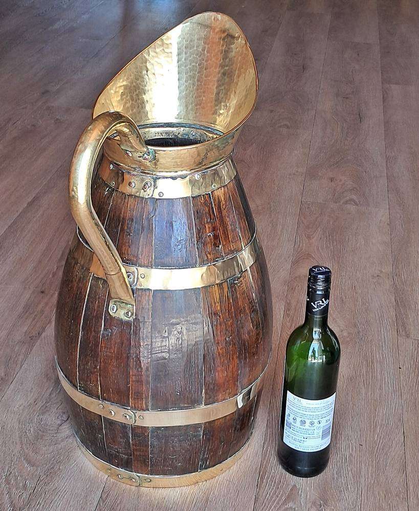 Large antique oak and brass jug