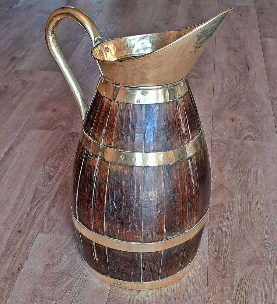 Large antique oak and brass jug