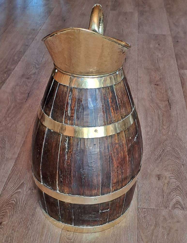 Large antique oak and brass jug