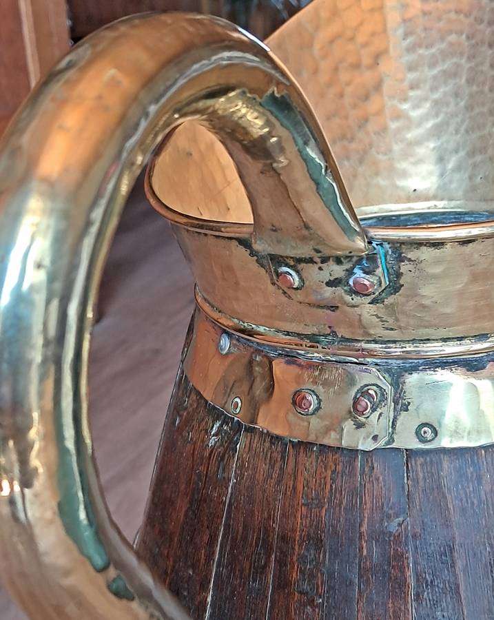 Large antique oak and brass jug