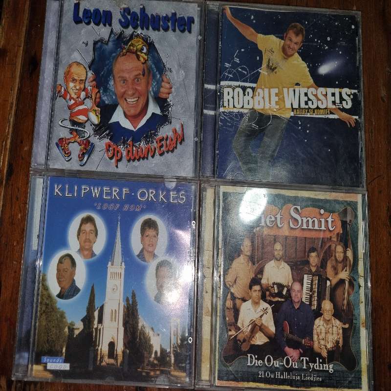 4 x Afrikaanse CD's - Leon Schuster, Klipwerf, Robbie Wessels & Piet Smit