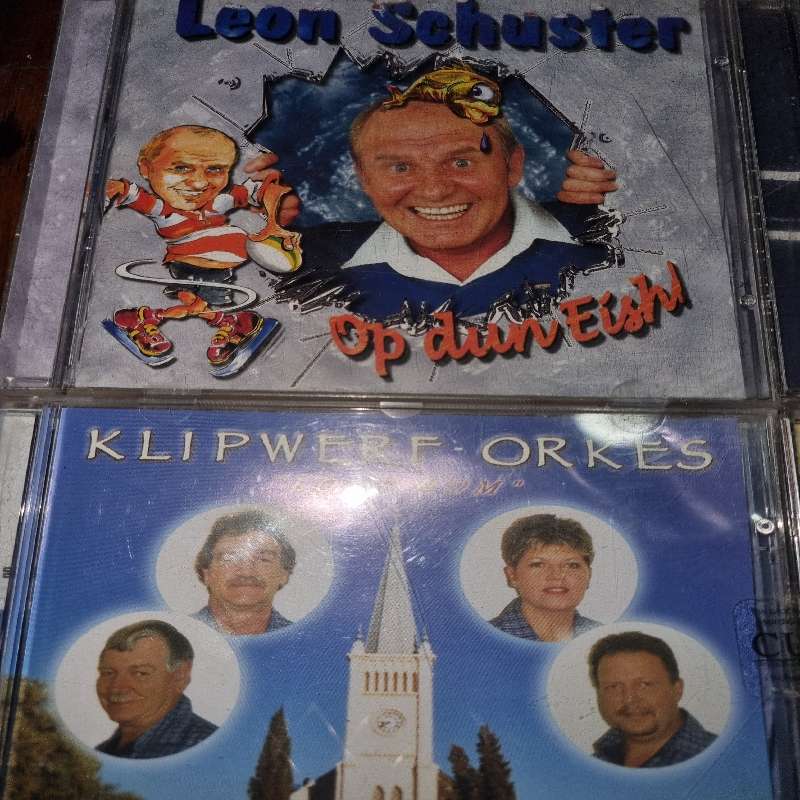 4 x Afrikaanse CD's - Leon Schuster, Klipwerf, Robbie Wessels & Piet Smit