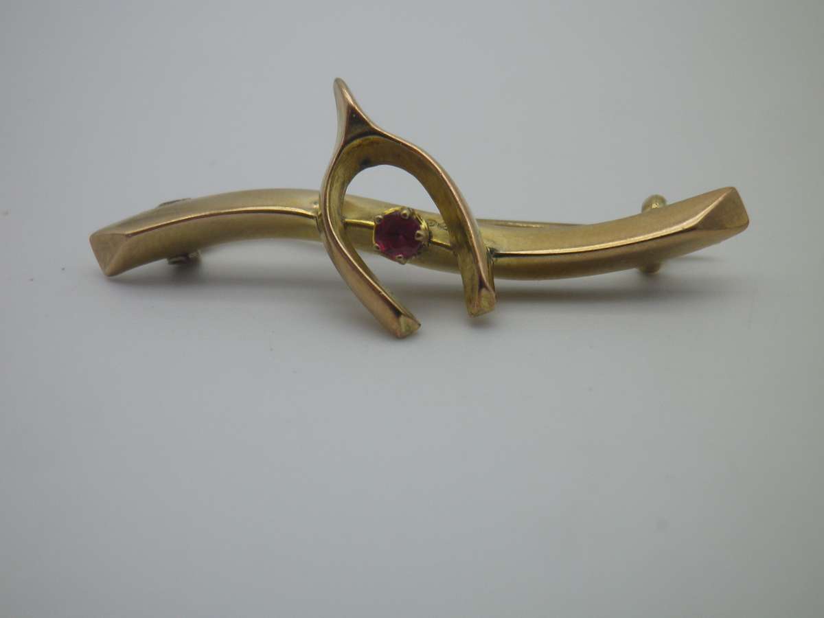 FOR DILA ONLY PLEASE. Hallmarked 9ct Gold & Ruby Lucky Wishbone brooch. Birmingham. 4cm 1.3g