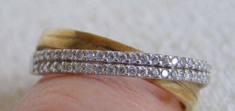 Gorgeous 9ct Gold cross over ring. 50 brilliant cut diamonds. Size O. 2.4g Valuation certificate.