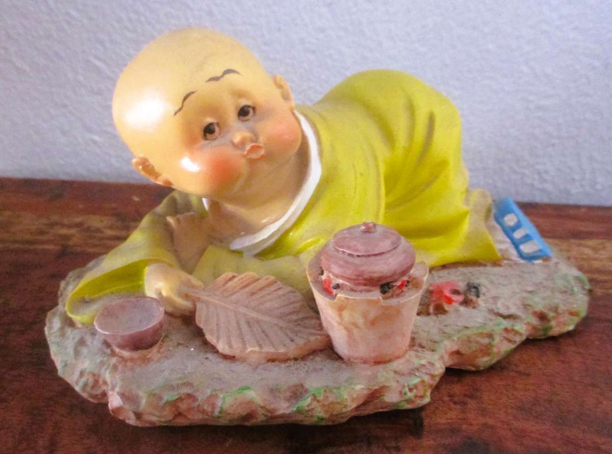 Vintage Shaolin Baby Monk Resin Figurene making a fire. Very Collectable. 140x100mm