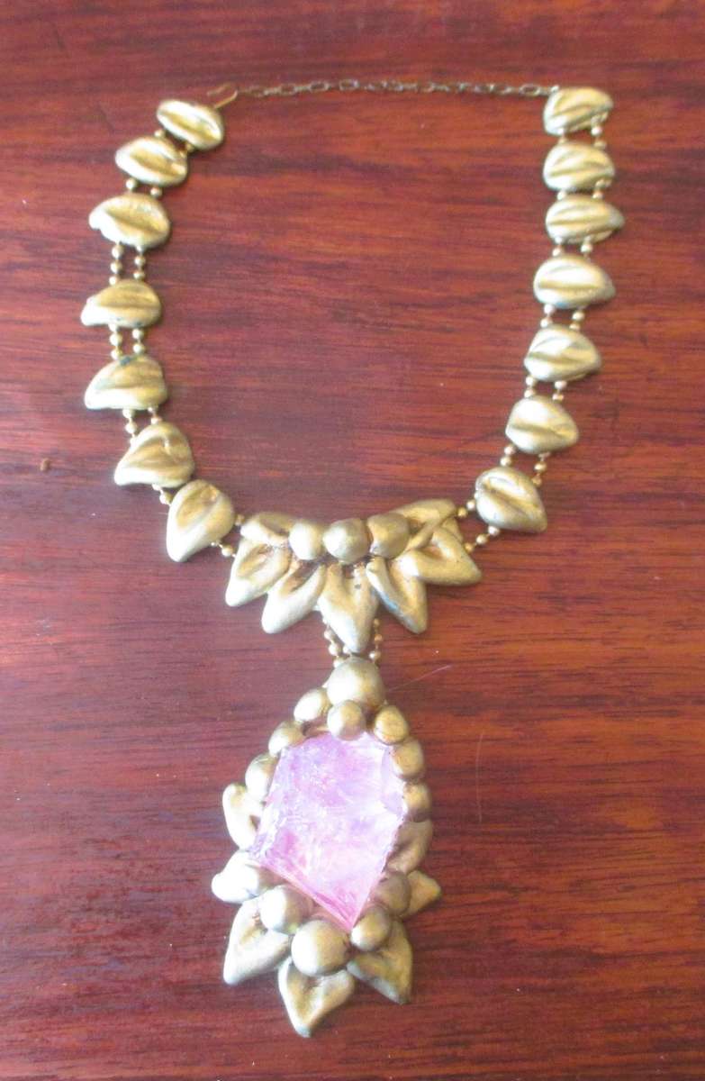 Bulky stage clay jewelry with large pink centre.