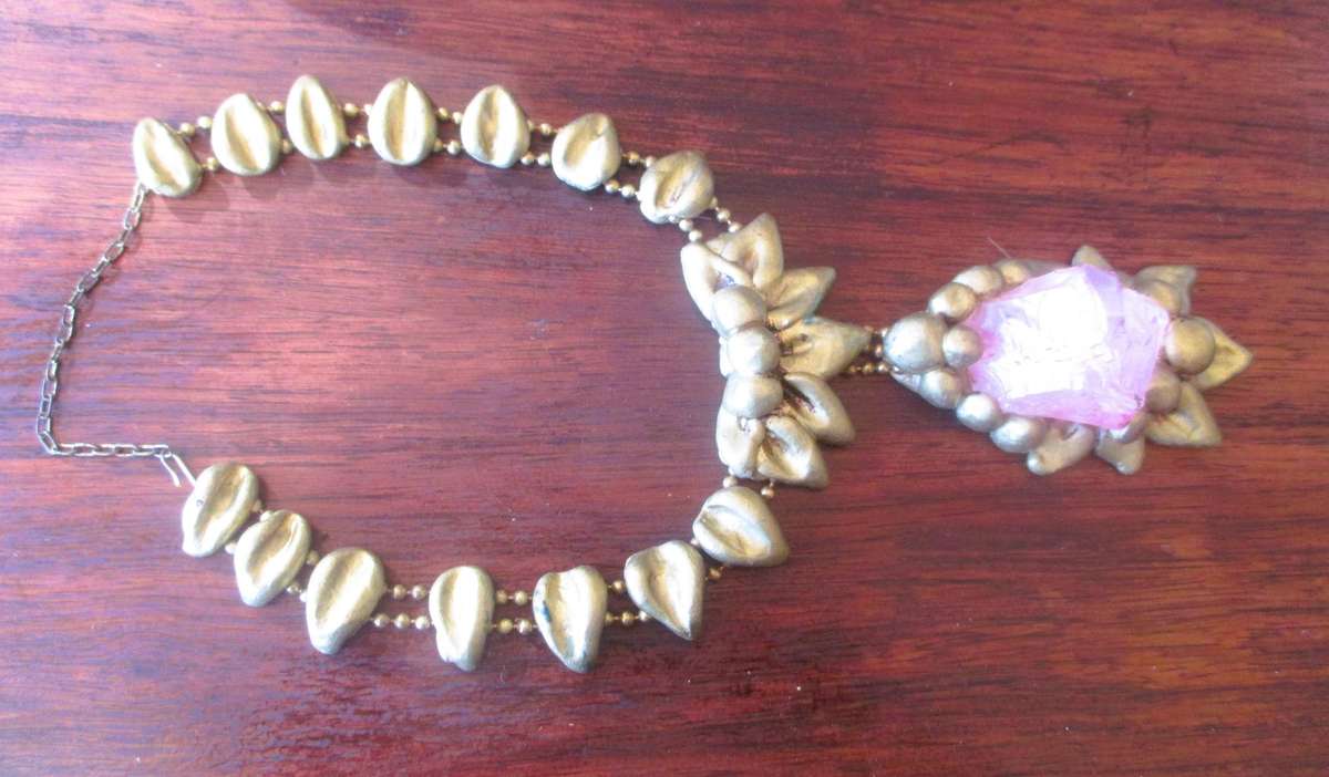 Bulky stage clay jewelry with large pink centre.