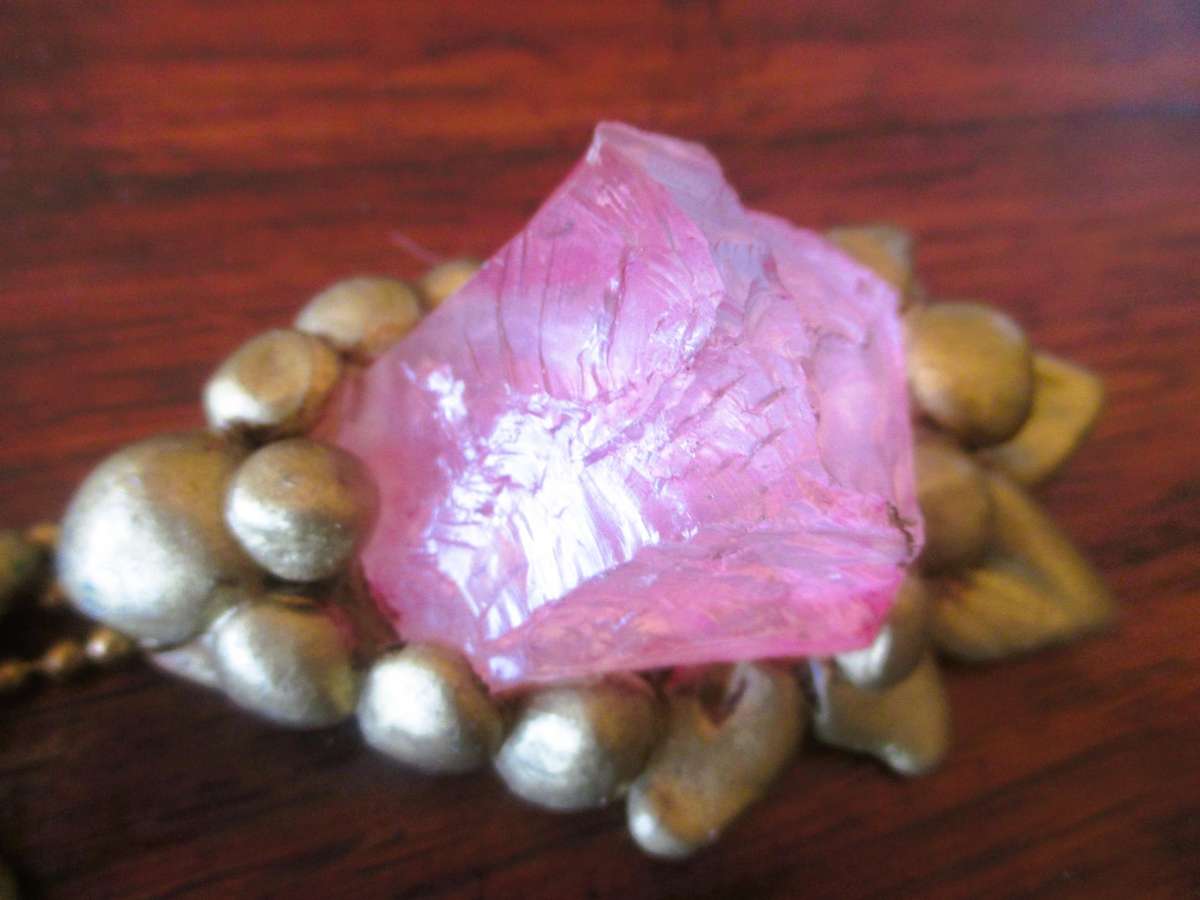 Bulky stage clay jewelry with large pink centre.