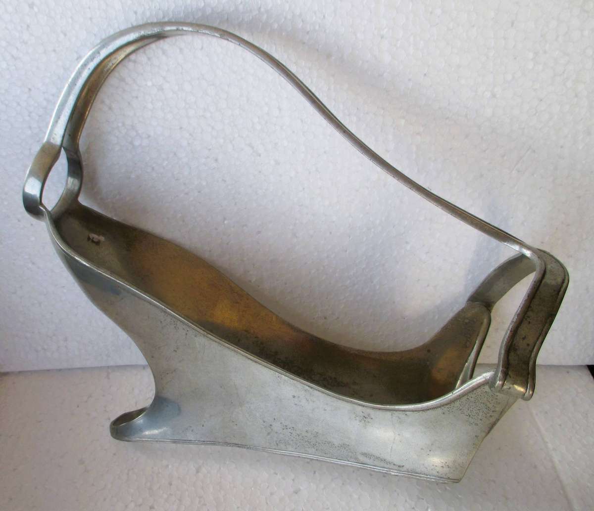 Mid century pewter wine bottle holder for display or serving, 25 cm long.