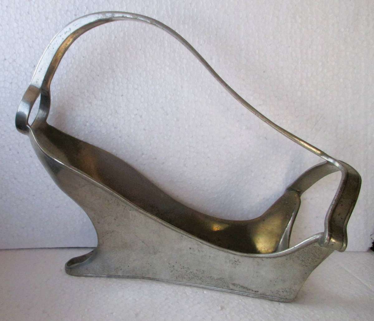 Mid century pewter wine bottle holder for display or serving, 25 cm long.