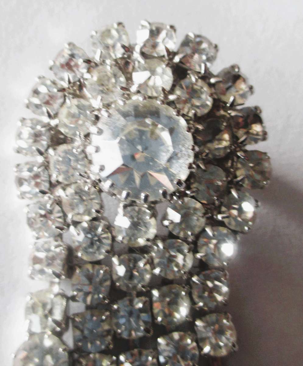 1950's vintage silver-tone brooch features sparkling crystals in a waterfall or fountain design